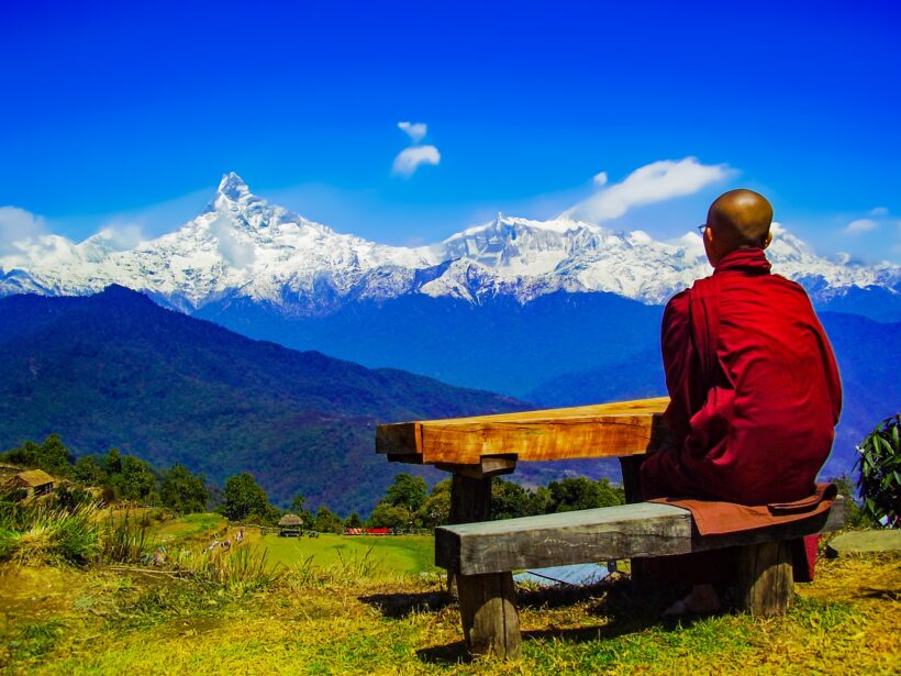 Monk looking at Fishtail Peak of Annapurna Mountain